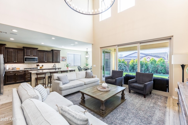 living room featuring a notable chandelier and light hardwood / wood-style floors