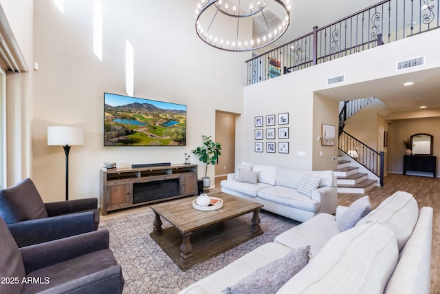 living room featuring an inviting chandelier and wood-type flooring