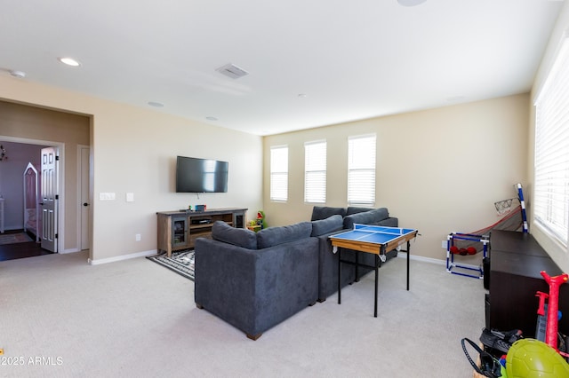 living room featuring a wealth of natural light and light colored carpet