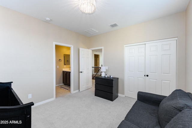 carpeted living room with a closet and ensuite bath