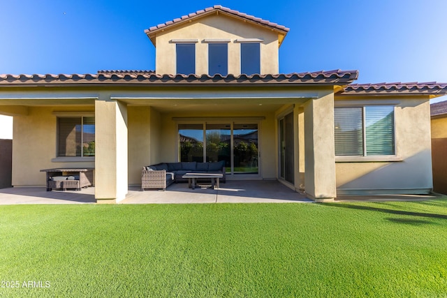 rear view of property featuring a patio, a yard, and an outdoor living space