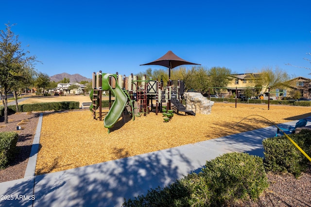 view of jungle gym with a mountain view