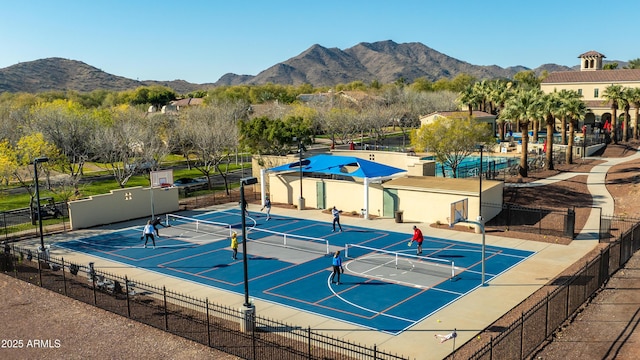 view of tennis court featuring a mountain view