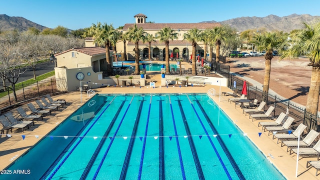 view of pool featuring a mountain view and a patio area