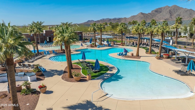 view of swimming pool with a mountain view and a patio