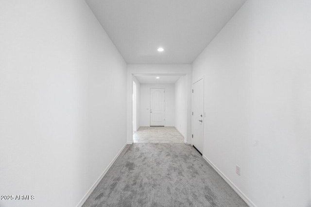 hallway featuring recessed lighting, carpet, and baseboards