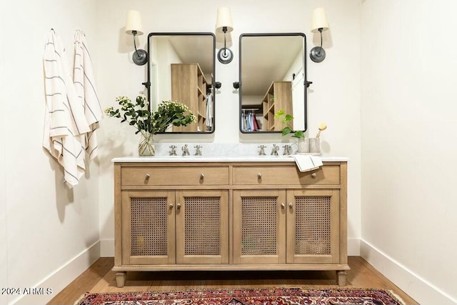 bathroom with hardwood / wood-style floors and vanity