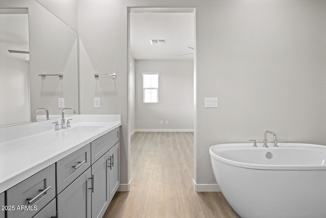 651 W Laredo St, Chandler, AZ 85225 - bathroom with vanity, wood finished floors, and a freestanding tub