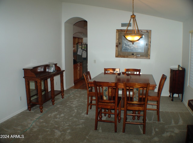 4506 E Lone Cactus Dr, Phoenix, AZ 85050 - carpeted dining area with visible vents, arched walkways, baseboards, and vaulted ceiling