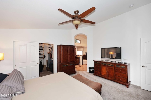 4506 E Lone Cactus Dr, Phoenix, AZ 85050 - bedroom featuring light carpet, arched walkways, a spacious closet, lofted ceiling, and a ceiling fan
