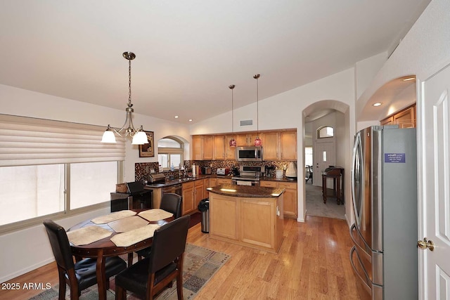 4506 E Lone Cactus Dr, Phoenix, AZ 85050 - dining room with arched walkways, lofted ceiling, and light wood-type flooring