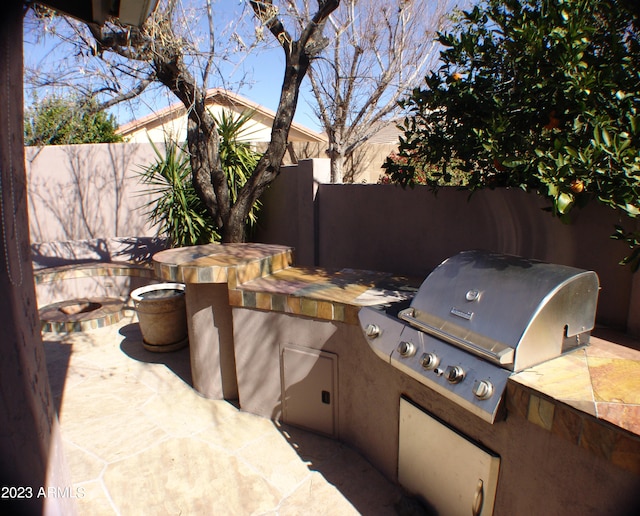 4506 E Lone Cactus Dr, Phoenix, AZ 85050 - view of patio featuring area for grilling, fence, and a grill