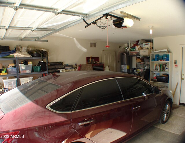 4506 E Lone Cactus Dr, Phoenix, AZ 85050 - garage with water heater, visible vents, and a garage door opener