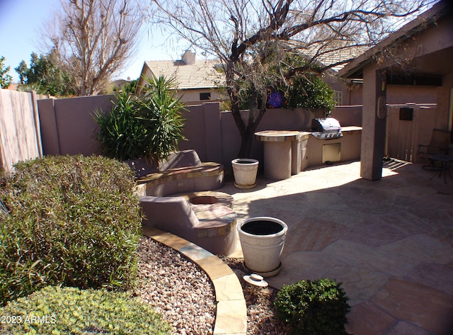 4506 E Lone Cactus Dr, Phoenix, AZ 85050 - view of patio featuring a fenced backyard, a grill, and an outdoor kitchen