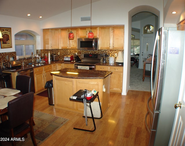 4506 E Lone Cactus Dr, Phoenix, AZ 85050 - kitchen with a sink, tasteful backsplash, a center island, stainless steel appliances, and arched walkways