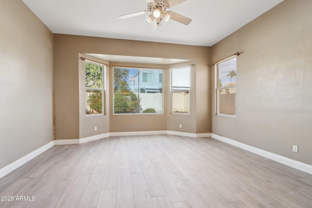 empty room with light hardwood / wood-style floors and ceiling fan