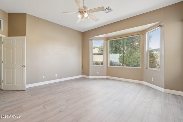 unfurnished room with ceiling fan, a healthy amount of sunlight, and light hardwood / wood-style flooring