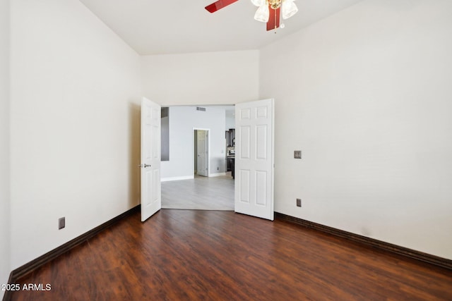 spare room with ceiling fan and dark hardwood / wood-style flooring