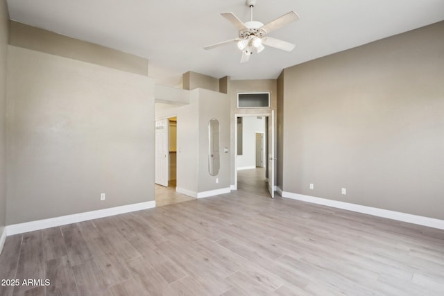 empty room with ceiling fan and light hardwood / wood-style floors