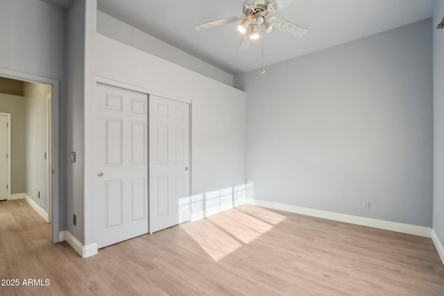 unfurnished bedroom with ceiling fan, a closet, and light hardwood / wood-style flooring