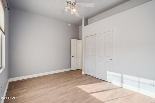 unfurnished bedroom with a closet, light hardwood / wood-style flooring, and ceiling fan