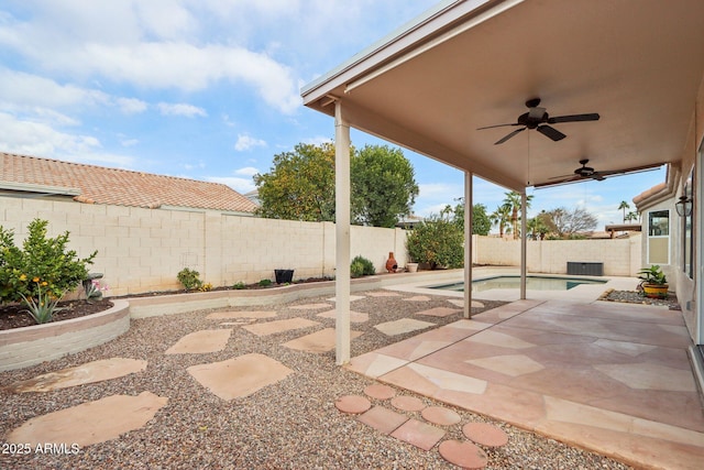 view of patio featuring ceiling fan and a fenced in pool