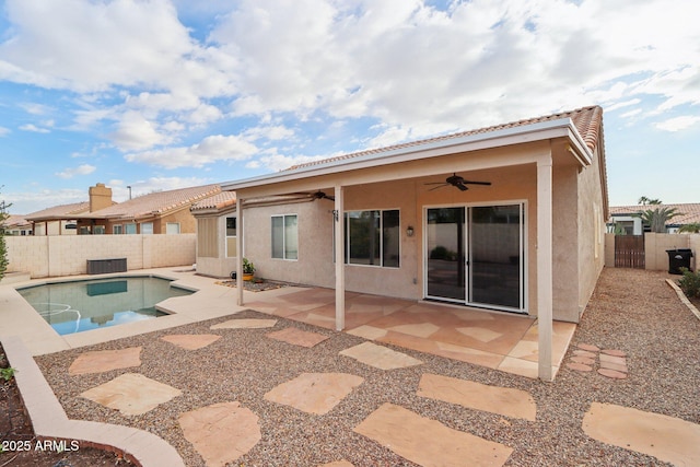 rear view of house with a fenced in pool, ceiling fan, cooling unit, and a patio