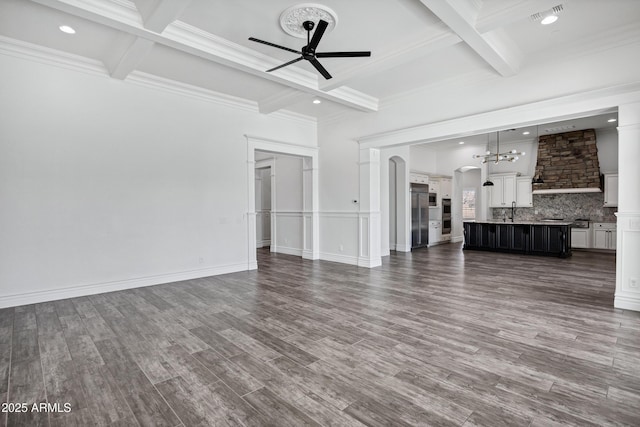 unfurnished living room featuring a ceiling fan, arched walkways, visible vents, and dark wood finished floors