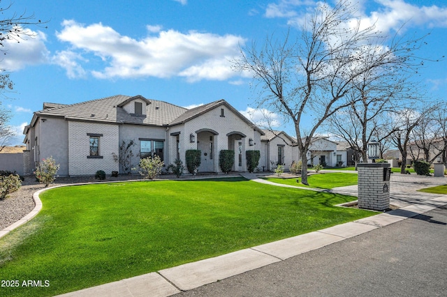 french provincial home featuring a front yard, a residential view, and stucco siding