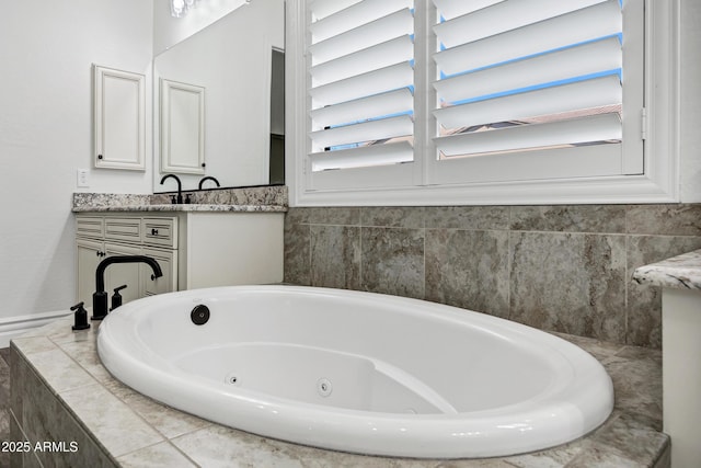 bathroom with plenty of natural light, vanity, and a whirlpool tub