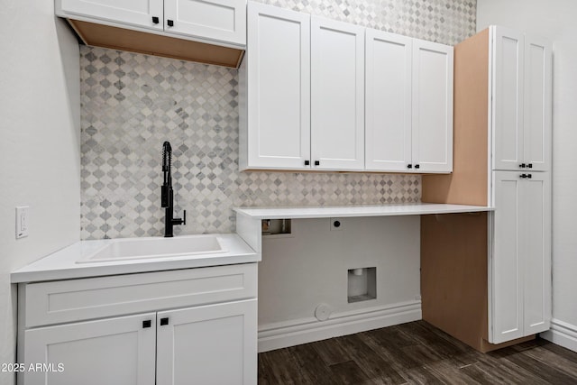 laundry room featuring washer hookup, a sink, cabinet space, dark wood-style floors, and electric dryer hookup