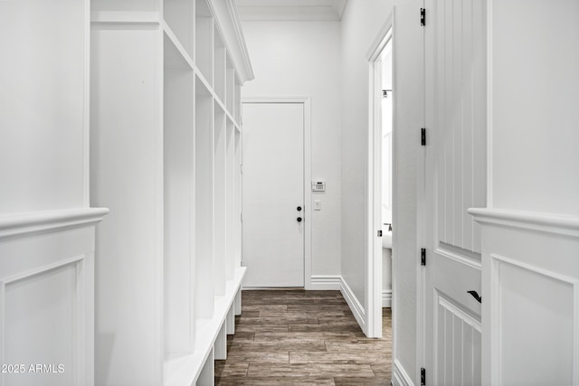 mudroom with ornamental molding and wood finished floors