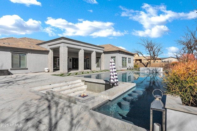 view of pool with a fire pit, a patio, fence, and a fenced in pool