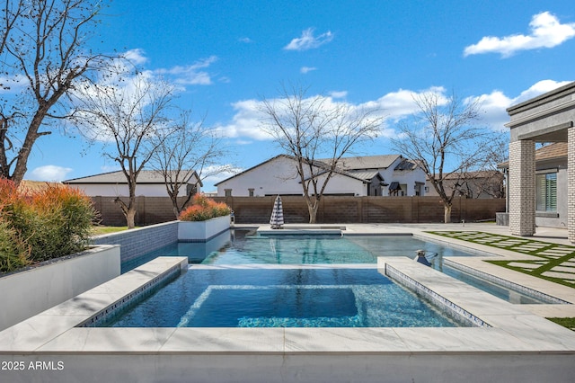 view of swimming pool featuring a fenced backyard and a pool with connected hot tub