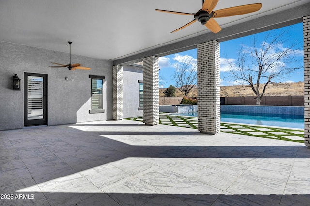 view of patio / terrace with ceiling fan, a fenced backyard, and a fenced in pool