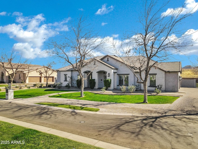 view of front of home with a front yard and stucco siding