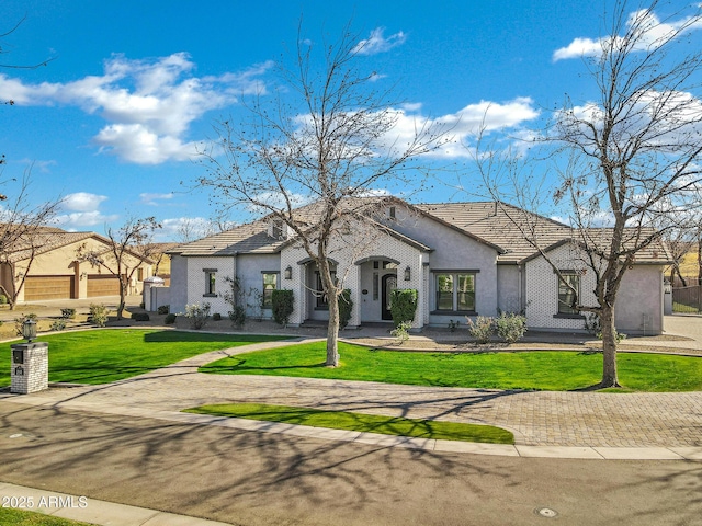 view of front of house with a front lawn and stucco siding