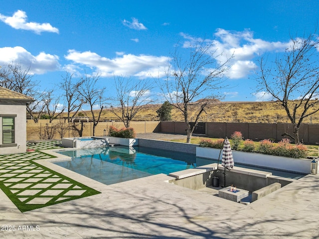 view of pool with a patio, an outdoor fire pit, a fenced backyard, an in ground hot tub, and a fenced in pool