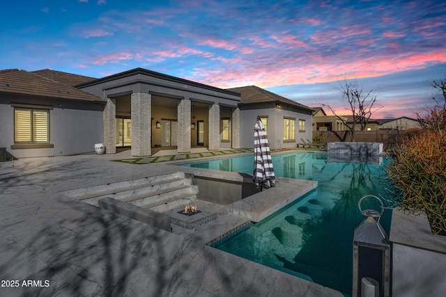 view of pool with a fire pit, a patio area, and a fenced in pool