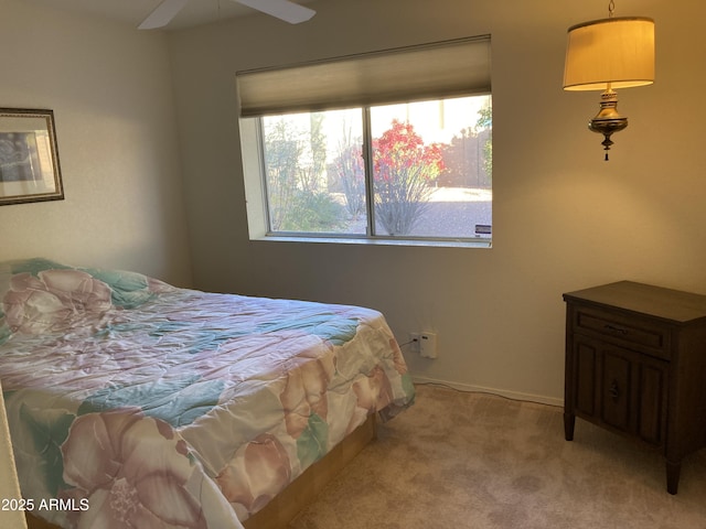 bedroom with ceiling fan and light colored carpet