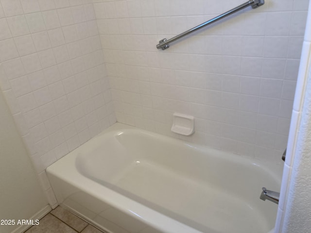 bathroom featuring tile patterned flooring and tiled shower / bath