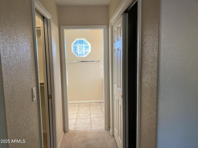 hallway with light tile patterned floors