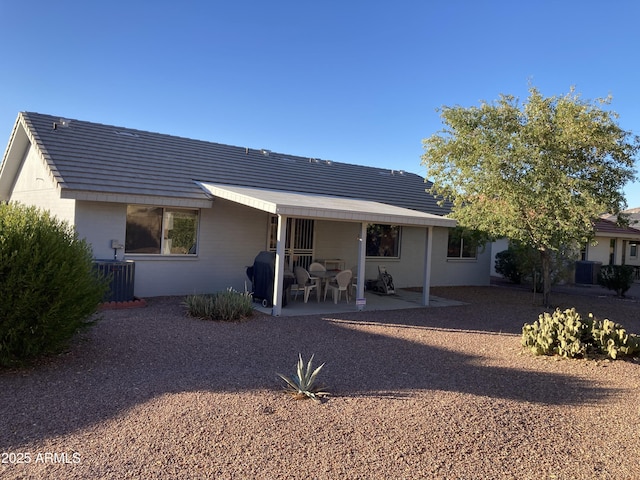 rear view of property with a patio area and central air condition unit