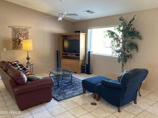 tiled living room featuring ceiling fan and lofted ceiling