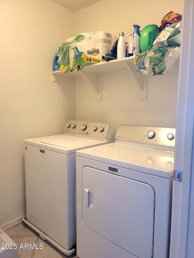 laundry area with tile patterned floors and washing machine and clothes dryer