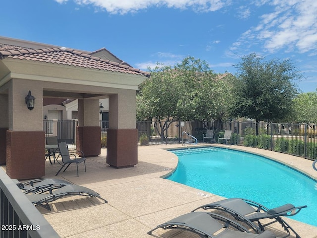 view of swimming pool with a patio area