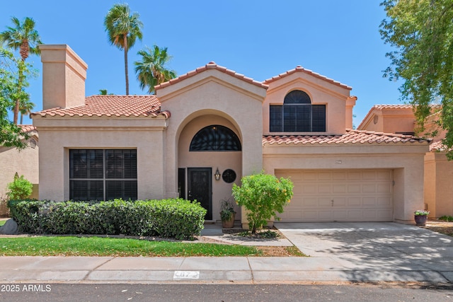 67 W Sarah Ln, Tempe, AZ 85284 - mediterranean / spanish house featuring stucco siding, concrete driveway, a tile roof, and a garage
