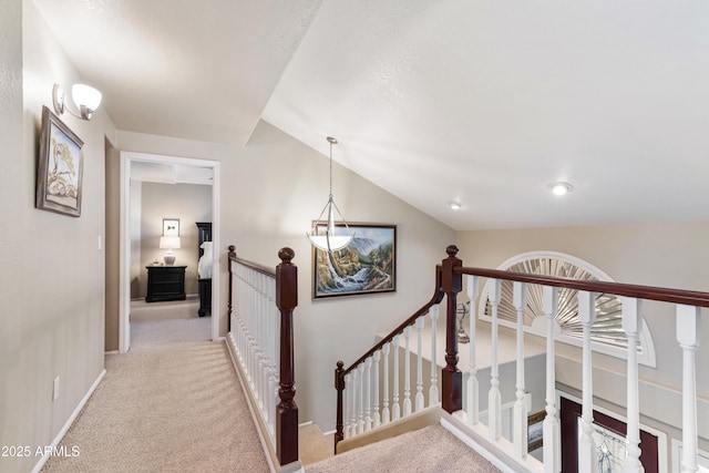 67 W Sarah Ln, Tempe, AZ 85284 - corridor with an upstairs landing, light colored carpet, baseboards, and vaulted ceiling