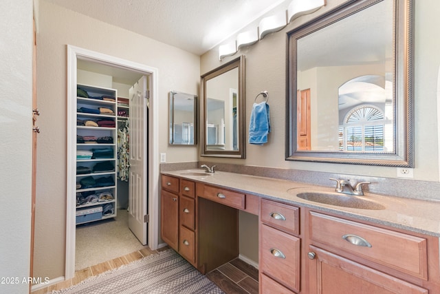 67 W Sarah Ln, Tempe, AZ 85284 - full bathroom with double vanity, a spacious closet, and wood finished floors