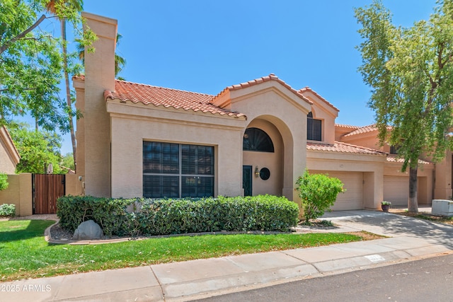 67 W Sarah Ln, Tempe, AZ 85284 - mediterranean / spanish-style house with a tiled roof, stucco siding, driveway, a gate, and a garage
